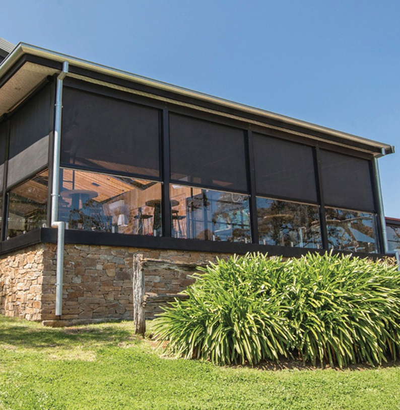 Outdoor patio with large glass windows.
