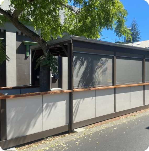Outdoor patio with tree and awning.