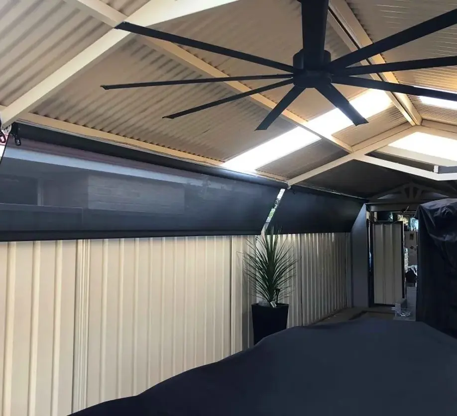 Outdoor patio with ceiling fan and blinds.